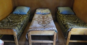 В доме: 3 односпальные деревянные кровати, обеденный стол, 3 стула, чайник, столешница для кухонных принадлежностей с полкой